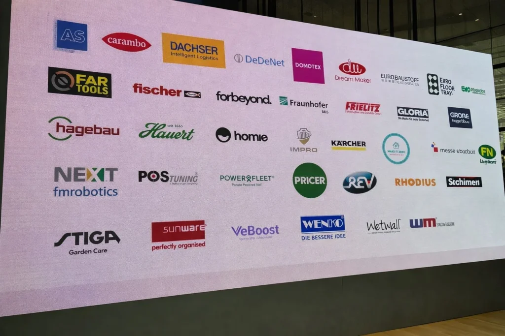 Logowand mit IMPRO Sicherheit & Service GmbH neben Marken wie Kärcher, Fischer und Hagebau